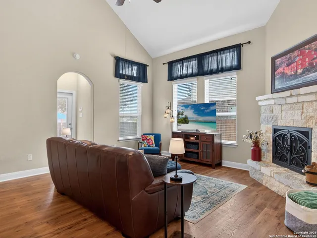 a living room with furniture and a fireplace