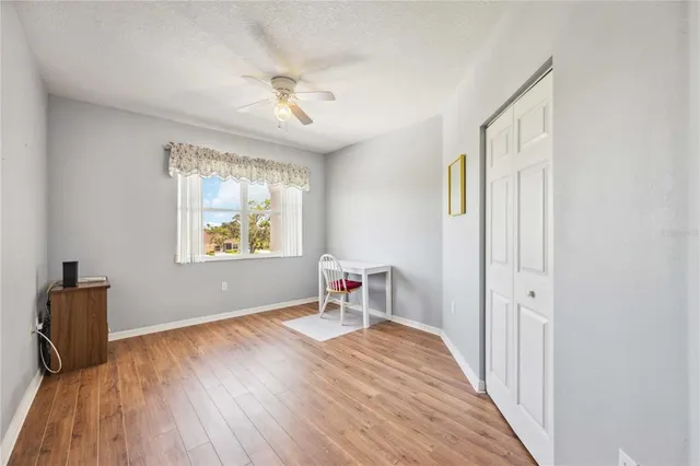 a view of a livingroom with wooden floor and a window