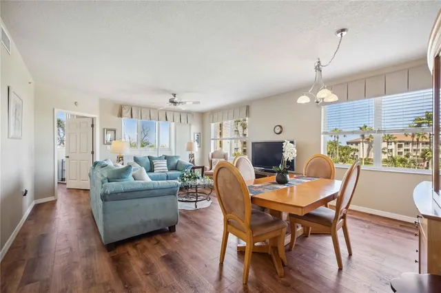 a living room with furniture a dining table and a fireplace