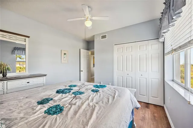 a spacious bedroom with a large bed and a chandelier