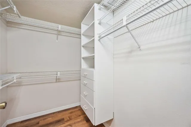 a view of walk in closet with empty racks