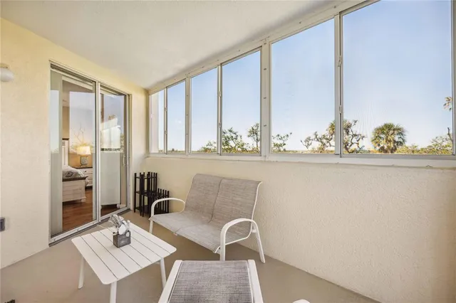 a view of a dining room with furniture and a window