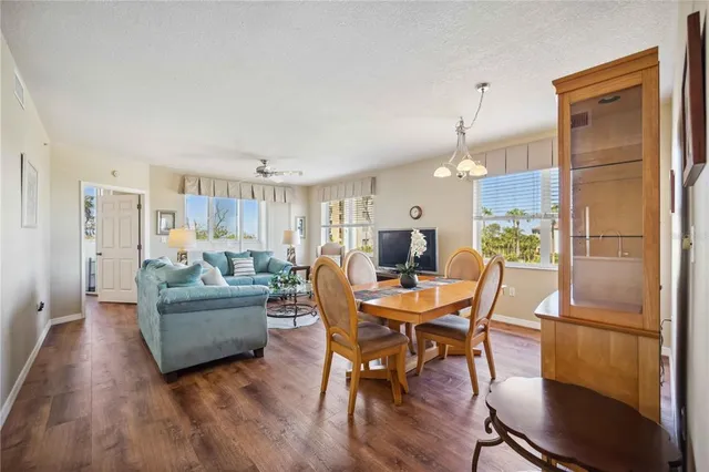 a living room with furniture and a dining table with kitchen view