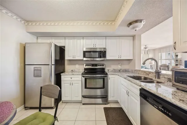 a kitchen with a stove a sink and a refrigerator
