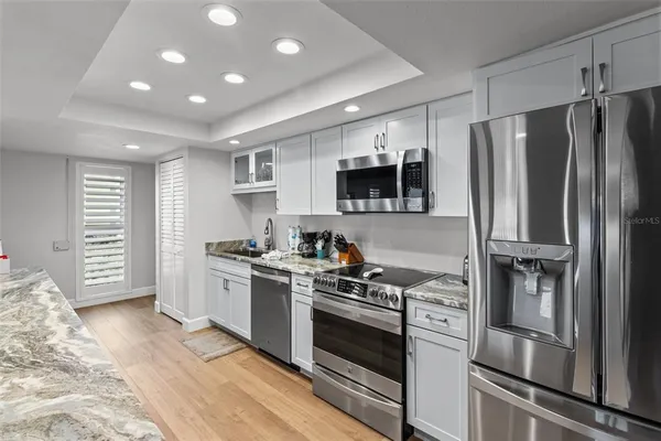 a kitchen with stainless steel appliances a stove a sink and a refrigerator