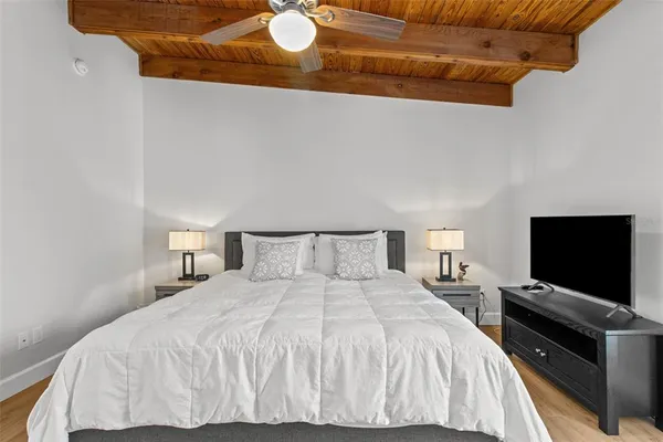 a bedroom with a bed and a television