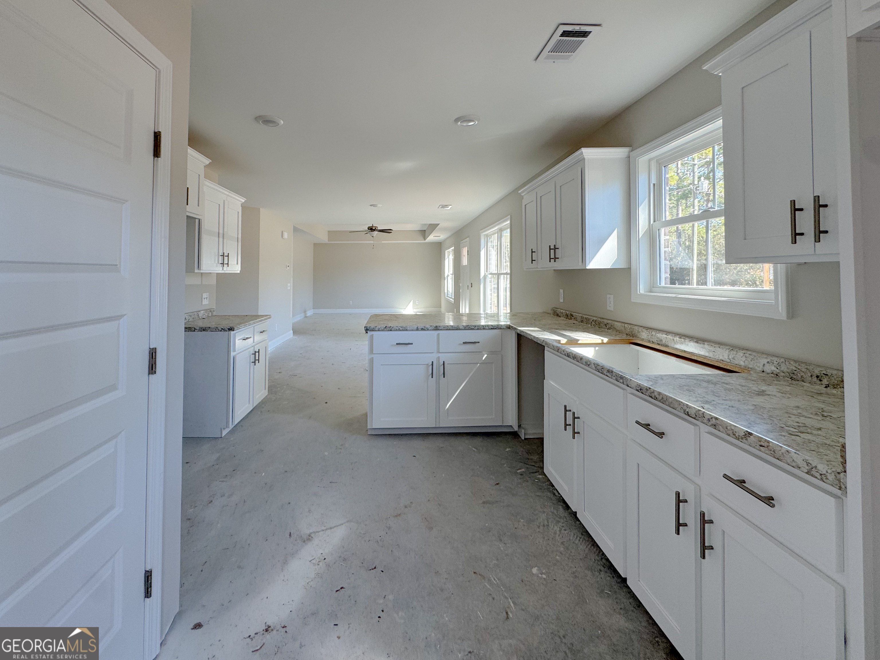 202 Zetterower Road Statesboro, GA 30458 - Photo 13 of 22 a large white kitchen with stainless steel appliances granite countertop a sink and cabinets