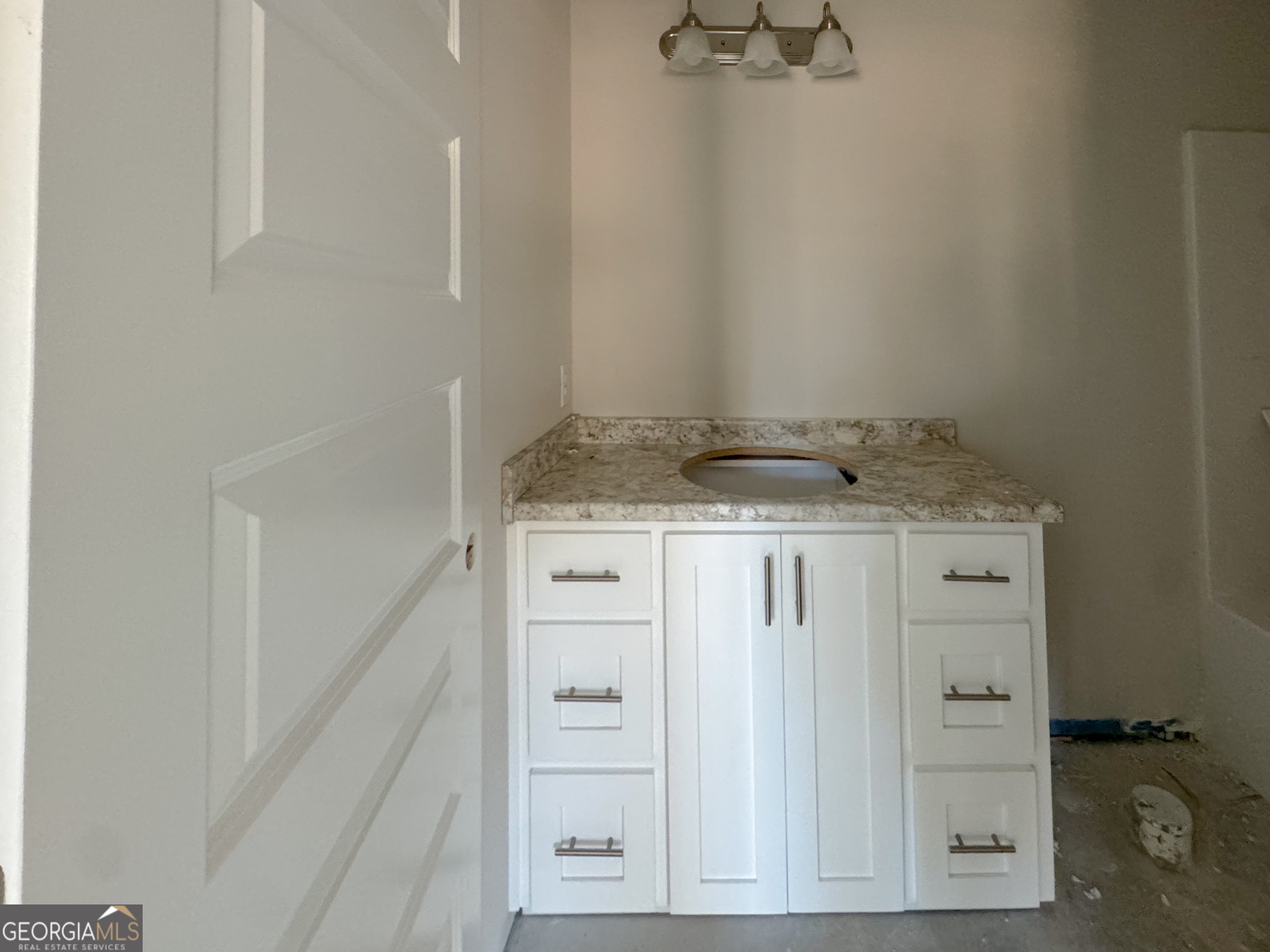202 Zetterower Road Statesboro, GA 30458 - Photo 18 of 22 a bathroom with a granite countertop sink and white cabinets