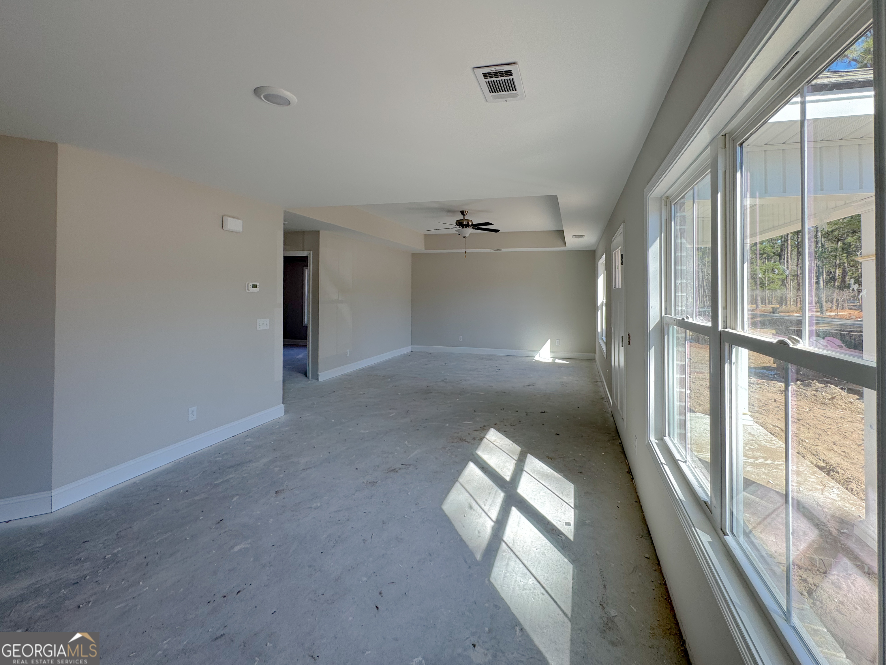 202 Zetterower Road Statesboro, GA 30458 - Photo 3 of 22 a view of empty room with windows and chandelier