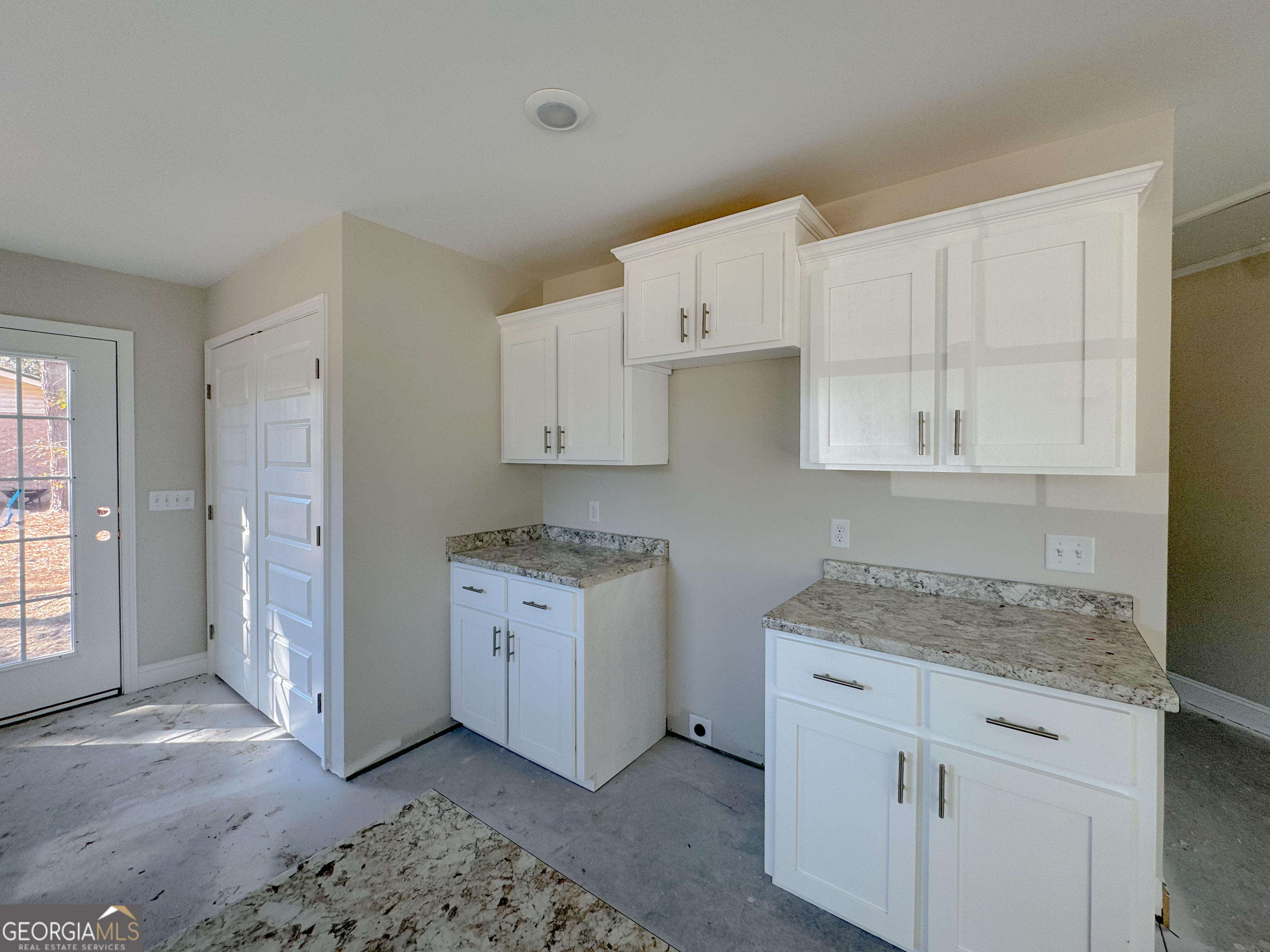 202 Zetterower Road Statesboro, GA 30458 - Photo 10 of 22 a kitchen with granite countertop white cabinets and white appliances