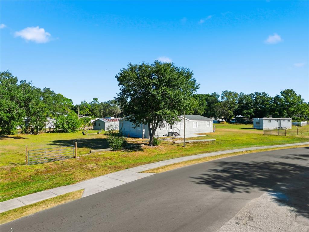12422 Balm Riverview Road Riverview, FL 33579 - Photo 4 of 13 a view of a swimming pool with an outdoor space and seating area
