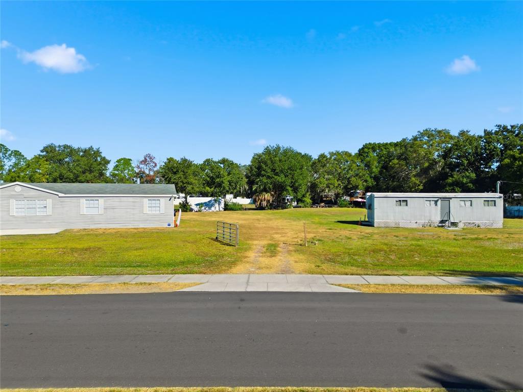 12422 Balm Riverview Road Riverview, FL 33579 - Photo 5 of 13 a view of yard with swimming pool and trees in the background