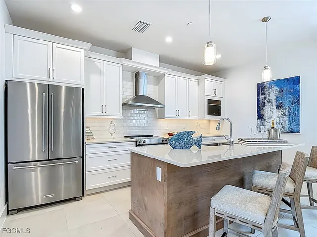 a kitchen with stainless steel appliances a refrigerator stove microwave and cabinets