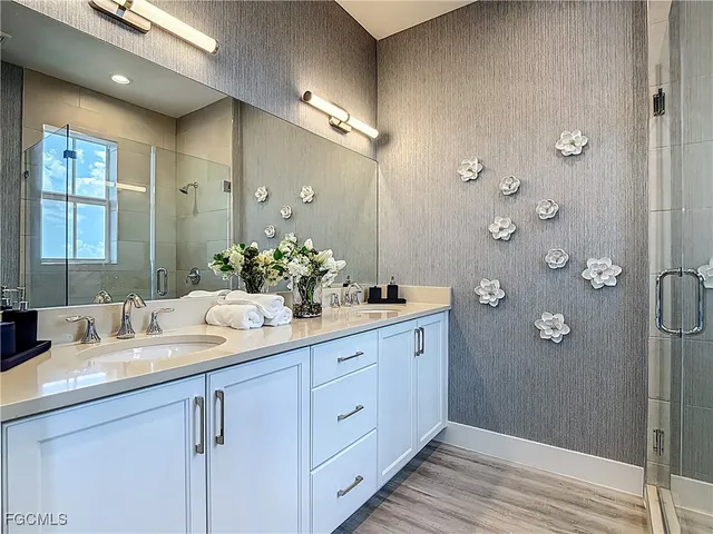 a bathroom with a double vanity sink and mirror