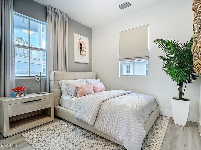 a bedroom with a bed and a potted plant