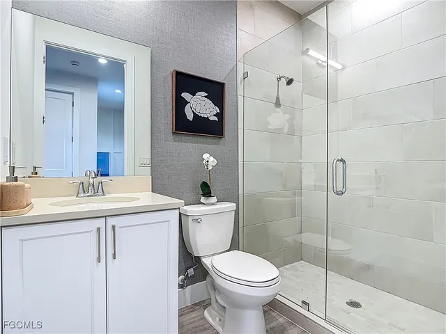 a bathroom with a toilet sink and shower