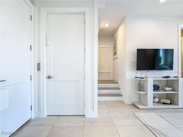 a view of a livingroom with wooden floor and flat screen tv