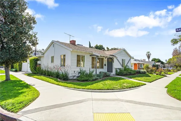 a front view of a house with a garden and pathway