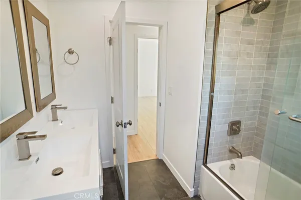 a bathroom with a tub sink and mirror