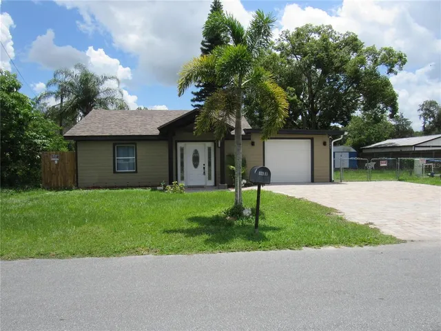 a front view of a house with a garden and yard