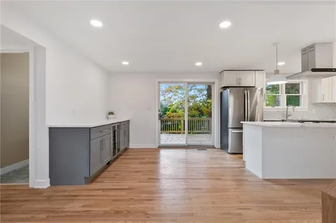a view of kitchen with stainless steel appliances granite countertop a refrigerator and a stove