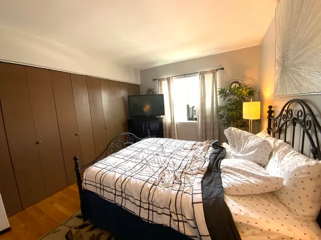 a bedroom with a bed and flat screen tv