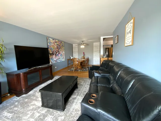 a living room with furniture and a potted plant
