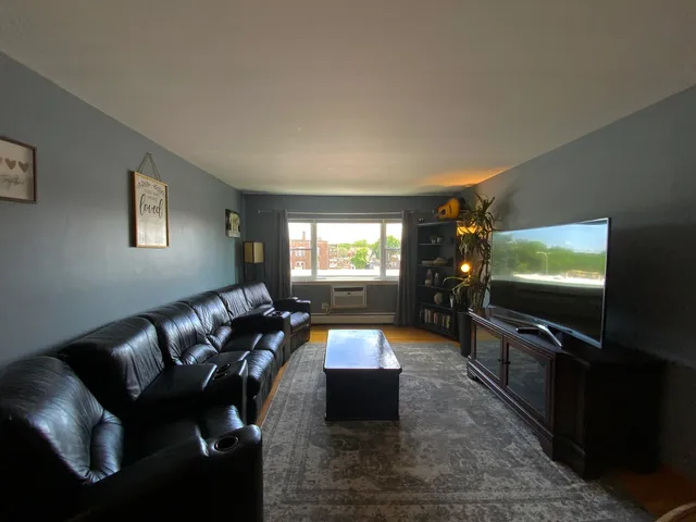 a view of a dining room with furniture and a chandelier