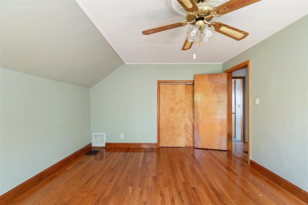 19 Butler Avenue Wakefield, MA 01880 - Photo 23 of 33 an empty room with wooden floor chandelier fan and windows