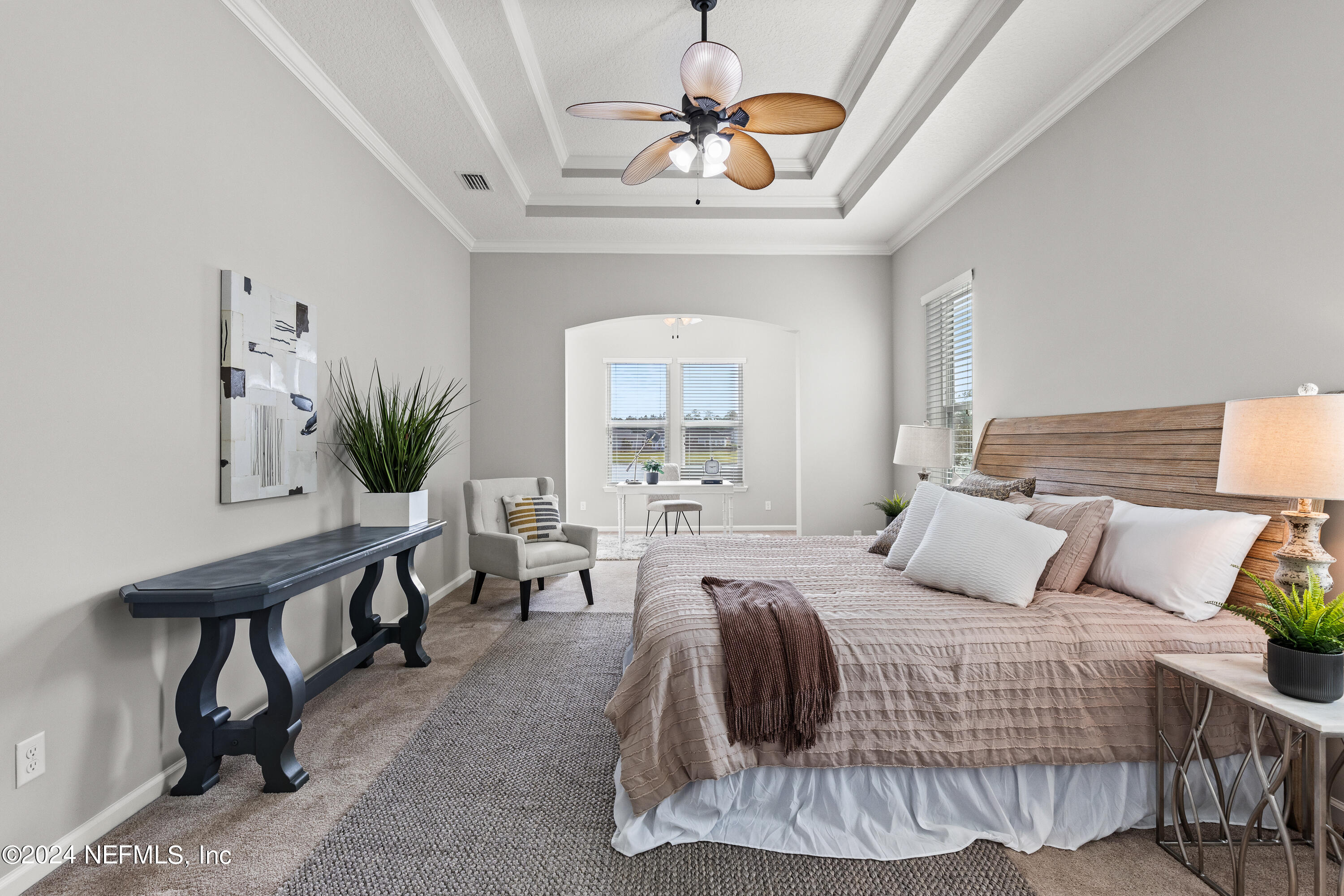 143 Willow Lake Drive St. Augustine, FL 32092 - Photo 12 of 45 a bedroom with a bed and a chandelier