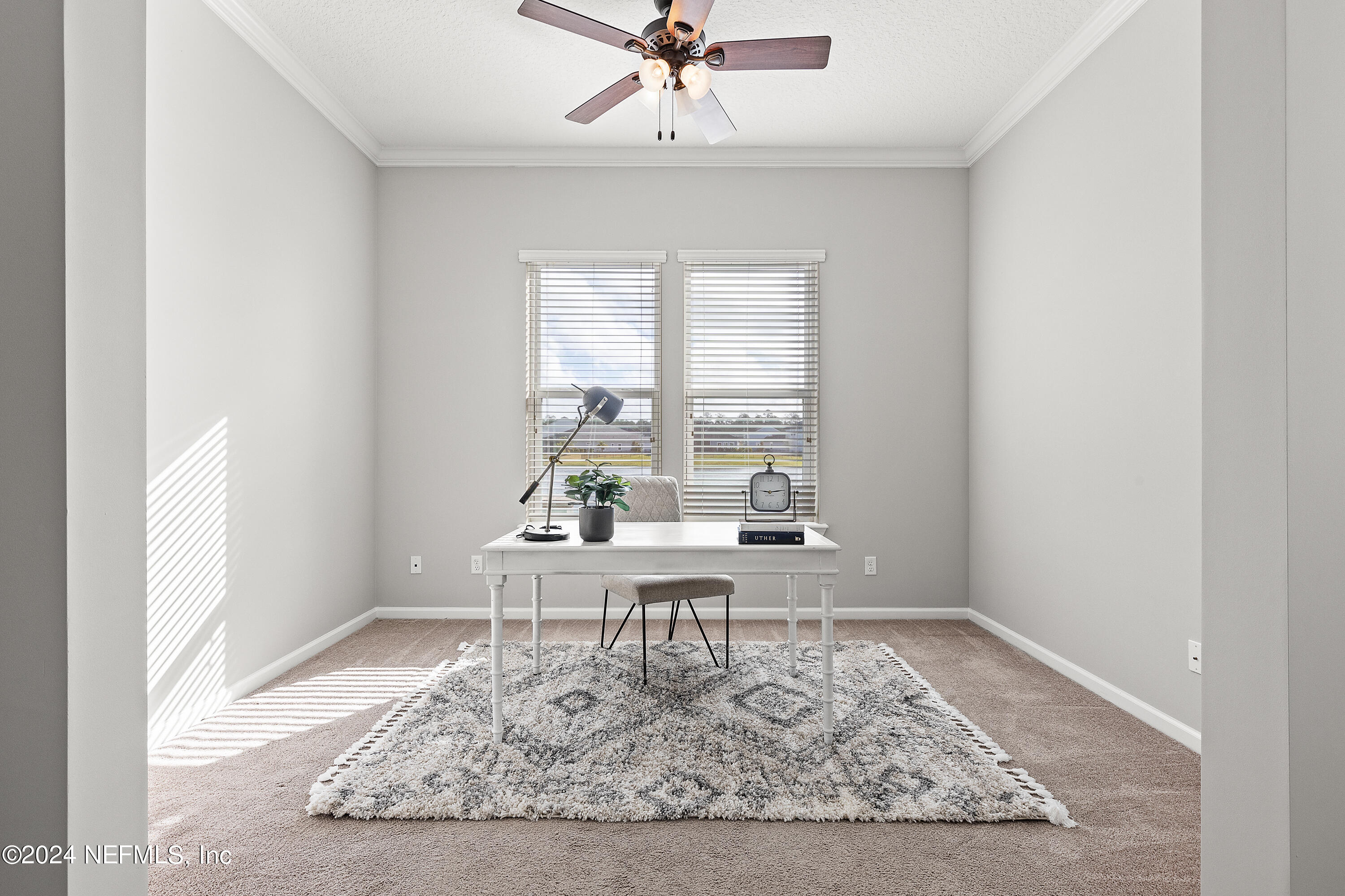 143 Willow Lake Drive St. Augustine, FL 32092 - Photo 13 of 45 a white chair sitting in a room next to a window