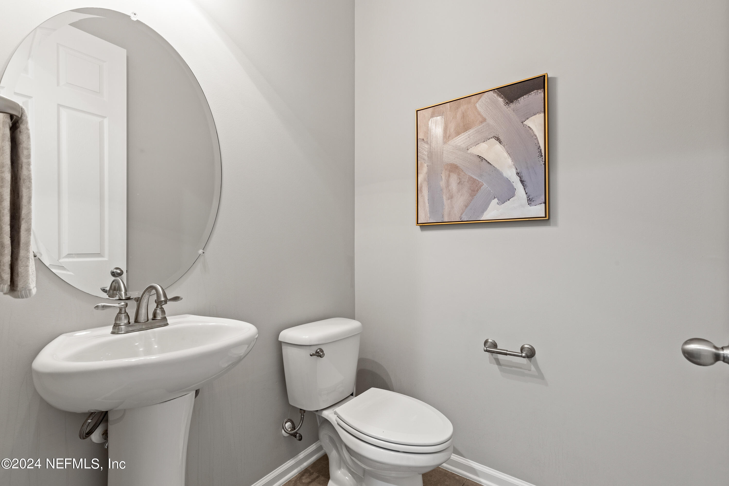 143 Willow Lake Drive St. Augustine, FL 32092 - Photo 19 of 45 a bathroom with a toilet a sink and a mirror