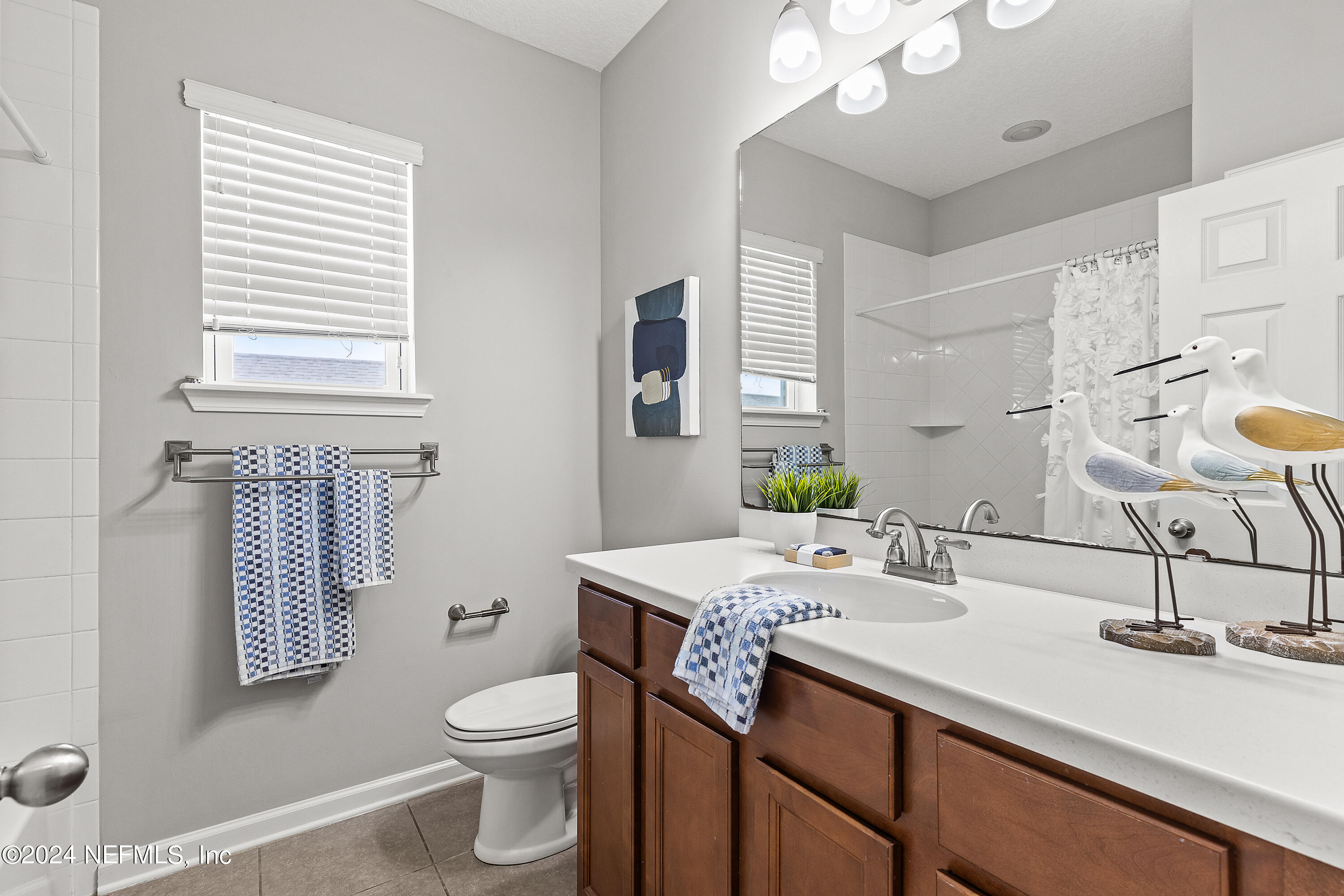 143 Willow Lake Drive St. Augustine, FL 32092 - Photo 23 of 45 a bathroom with a sink a toilet and mirror