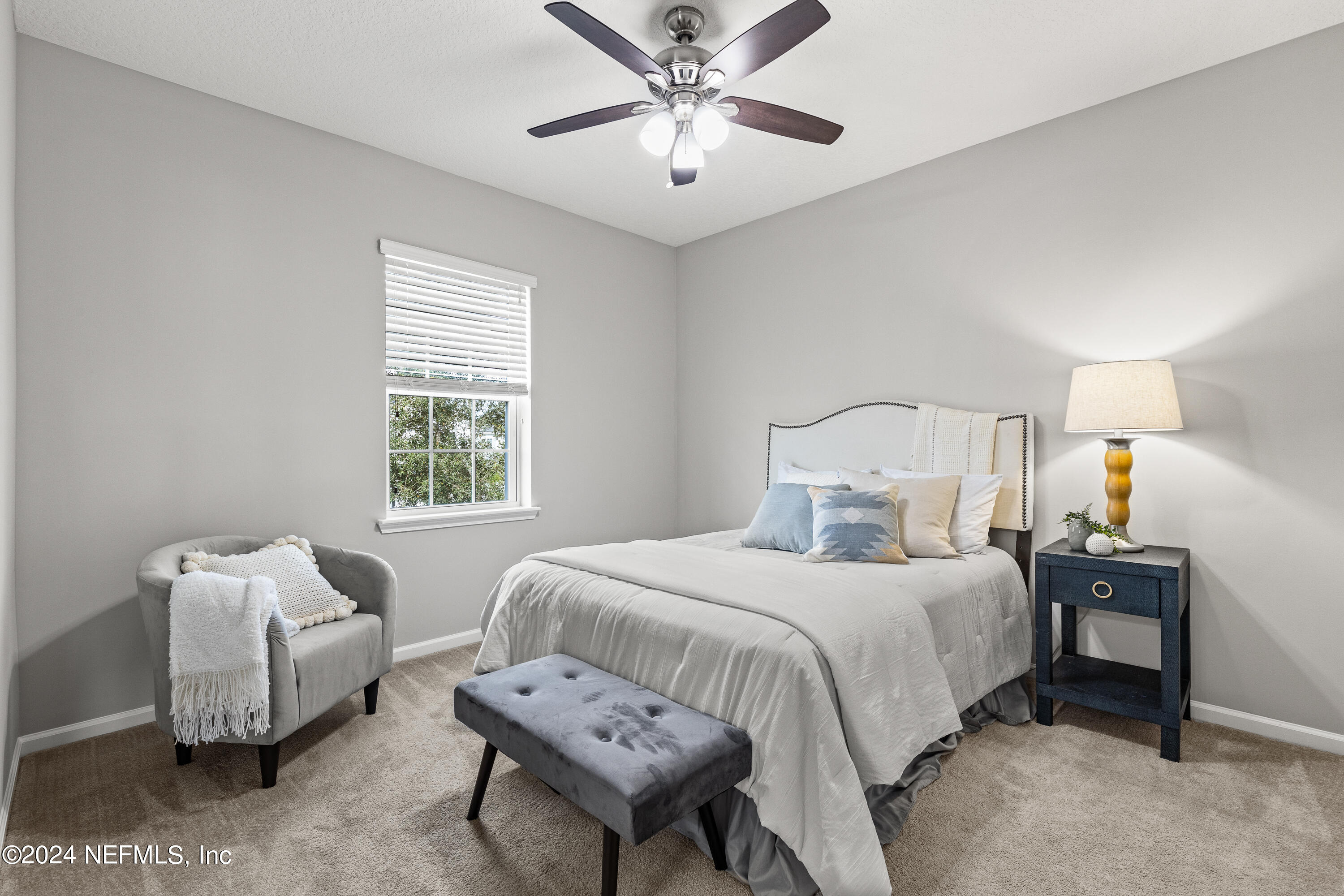 143 Willow Lake Drive St. Augustine, FL 32092 - Photo 24 of 45 a bedroom with a bed and a chandelier