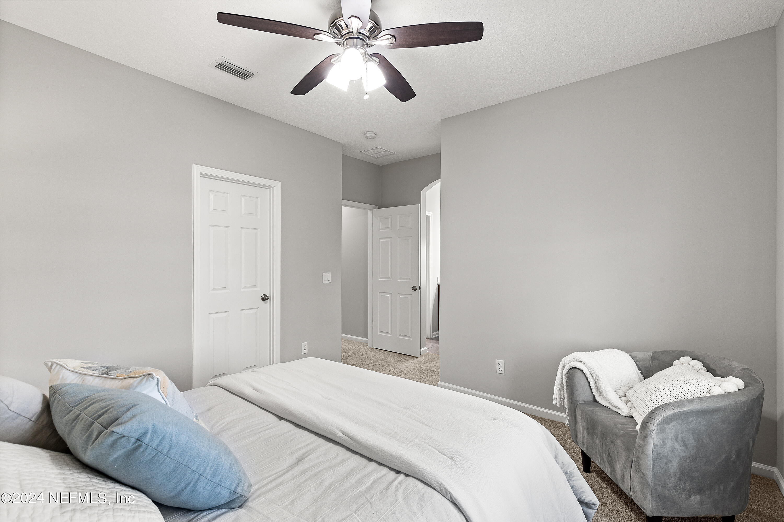 143 Willow Lake Drive St. Augustine, FL 32092 - Photo 25 of 45 a bedroom with a bed and a chair