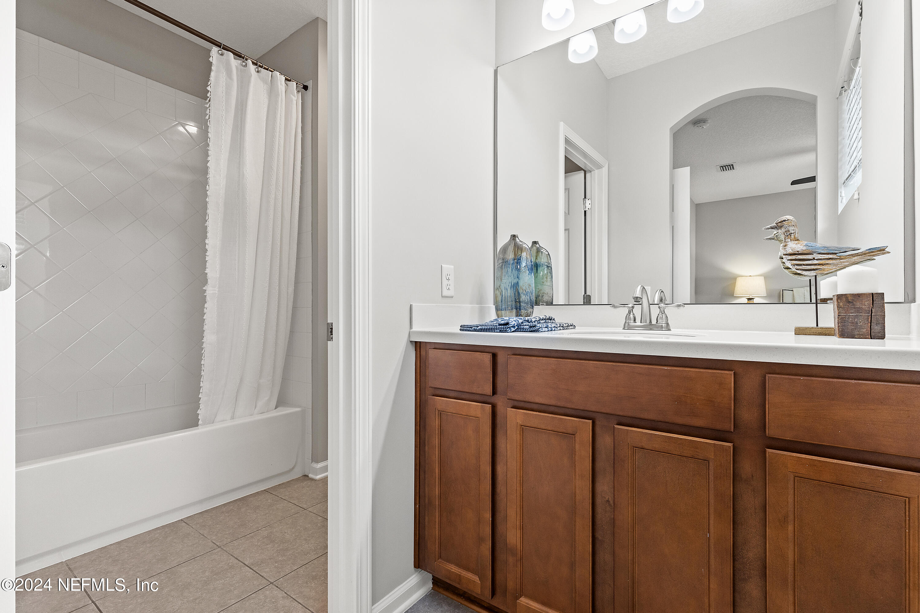143 Willow Lake Drive St. Augustine, FL 32092 - Photo 27 of 45 a bathroom with a double vanity sink and a mirror