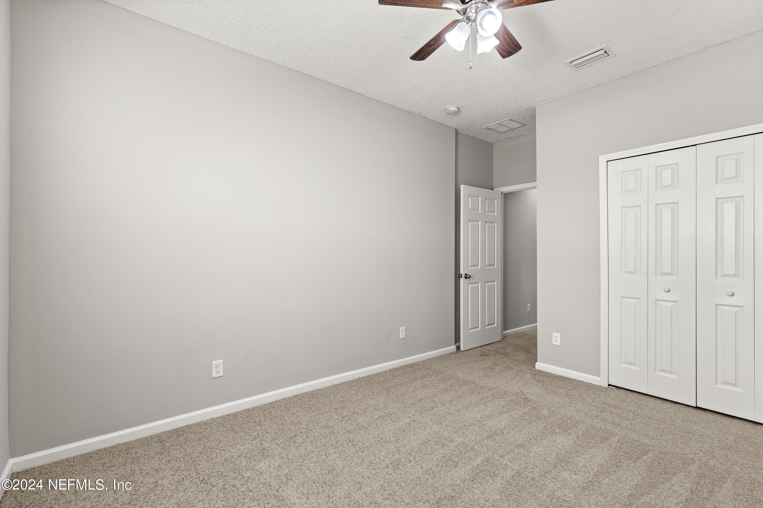 143 Willow Lake Drive St. Augustine, FL 32092 - Photo 31 of 45 an empty room with a ceiling fan and carpet