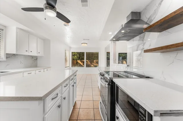 a kitchen with a sink stove and cabinets