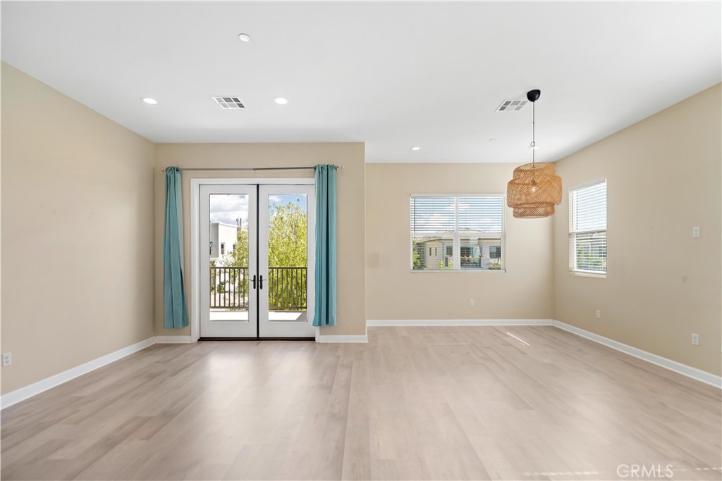 199 Follyhatch Irvine, CA 92618 - Photo 12 of 32 an empty room with wooden floor and outdoor view