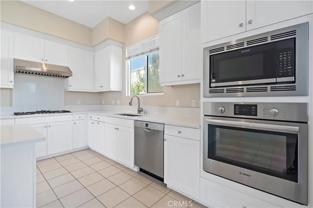 a kitchen with stainless steel appliances a stove microwave and cabinets