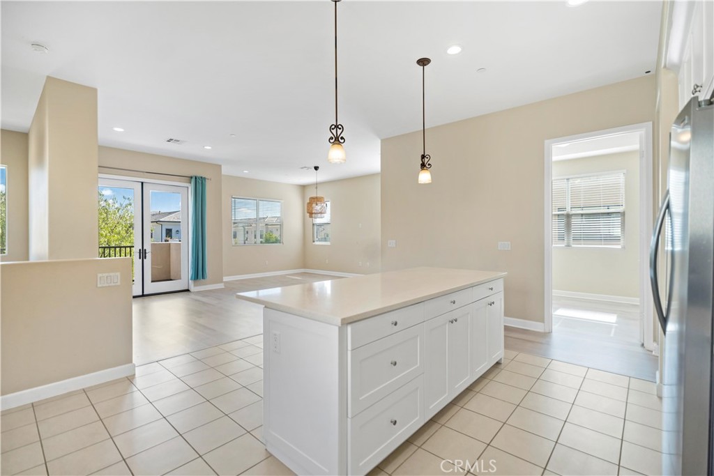 199 Follyhatch Irvine, CA 92618 - Photo 20 of 32 a view of a kitchen with center island and wooden floor