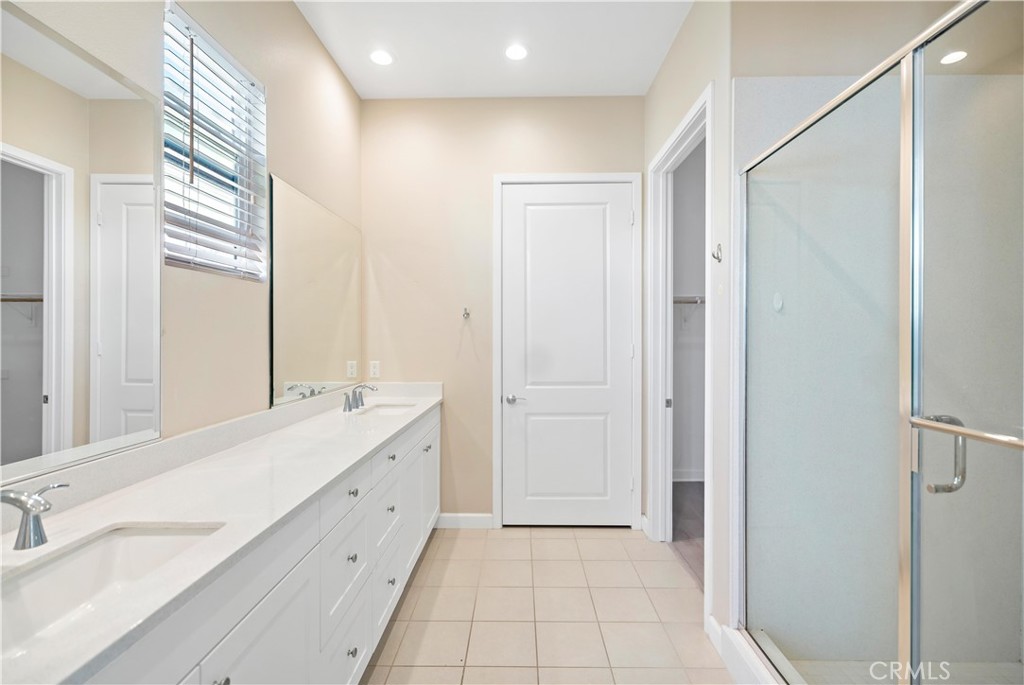 199 Follyhatch Irvine, CA 92618 - Photo 30 of 32 a spacious bathroom with a double vanity sink a mirror and a shower