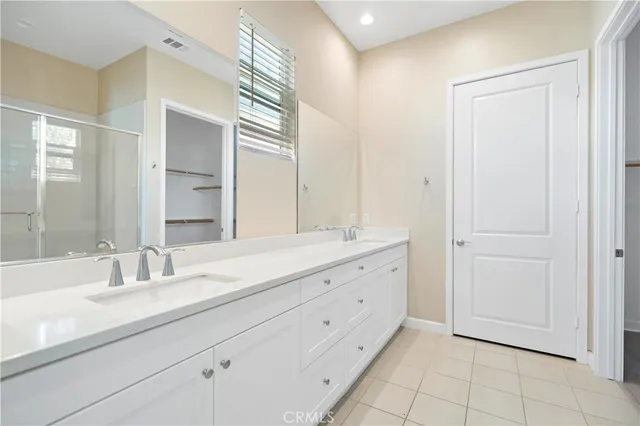 a bathroom with a double vanity sink and mirror