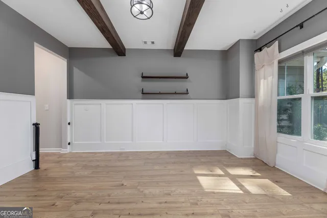 a view of a livingroom with furniture a fireplace and wooden floor