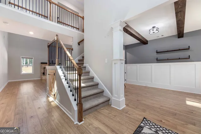 a living room with furniture and a dining table with kitchen view