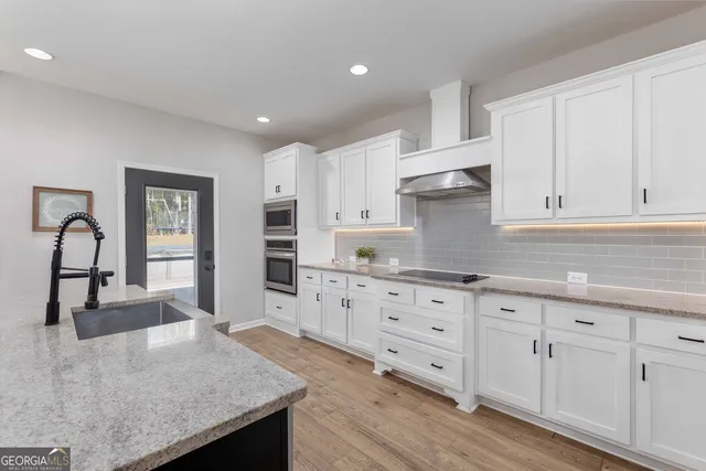 a spacious bathroom with a granite countertop sink mirror and shower