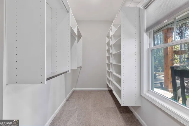 an empty room with windows and fan view