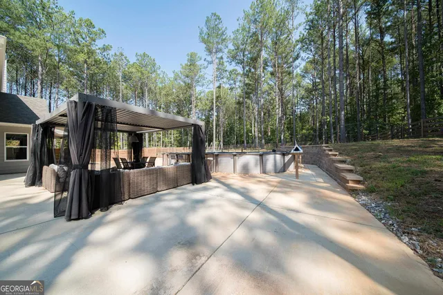 a backyard of a house with table and chairs