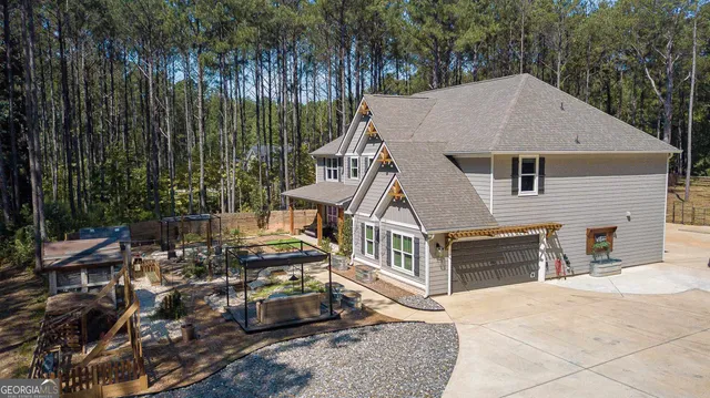 a aerial view of a house with a garden and trees