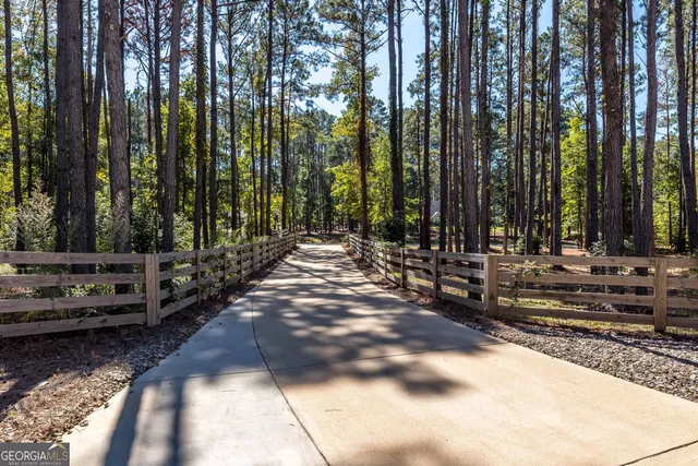 a view of backyard with swimming pool and sitting area